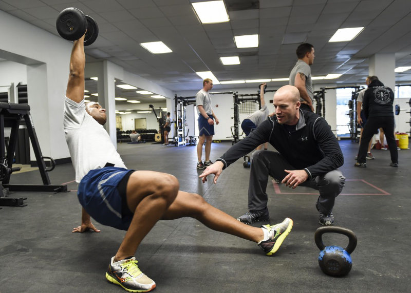 Athletic trainer instructing an athlete