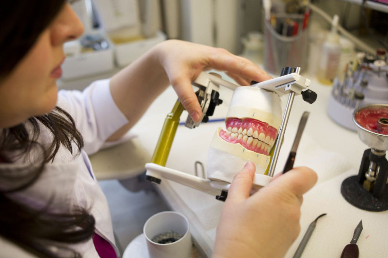 A denturist working on choppers