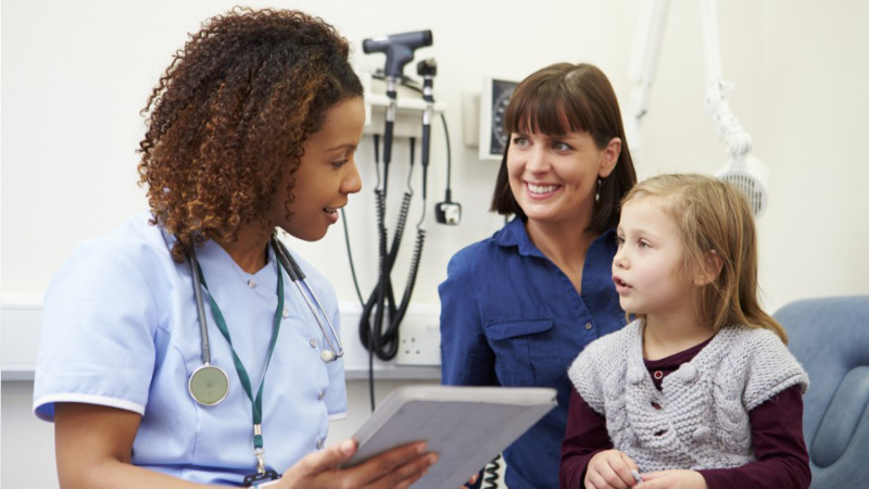 A medical assistant checking in a new patient