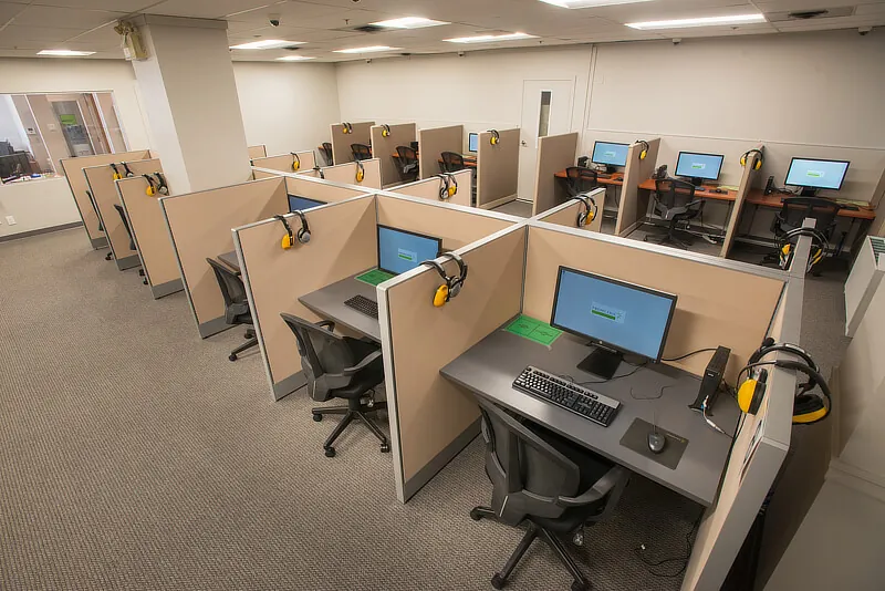 A typical test room with privacy desks and computer equipment